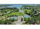 Beautiful aerial view of tennis courts, putting green and lake in a serene residential area at 175 Rehoboth Ln, Mooresville, NC 28117
