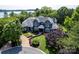 Expansive aerial view showcasing the property's landscaping, circular driveway, and proximity to the lake at 175 Rehoboth Ln, Mooresville, NC 28117