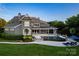 Gorgeous backyard oasis featuring a pool, outdoor seating, a covered patio, and beautifully landscaped lawn at 175 Rehoboth Ln, Mooresville, NC 28117
