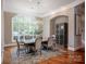 Elegant dining room features a large window, hardwood floors, and stylish chandelier at 175 Rehoboth Ln, Mooresville, NC 28117