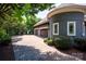 Stunning home exterior featuring a three-car garage, manicured landscaping, and lush greenery at 175 Rehoboth Ln, Mooresville, NC 28117
