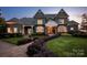 Elegant home featuring manicured landscaping, a circular driveway, and classic architectural details at 175 Rehoboth Ln, Mooresville, NC 28117