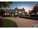 Stately gray two-story home showcasing beautiful landscaping and a stone driveway leading up to the inviting front entrance at 175 Rehoboth Ln, Mooresville, NC 28117