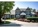 Stately gray two-story home showcasing beautiful landscaping and a stone driveway leading up to the inviting front entrance at 175 Rehoboth Ln, Mooresville, NC 28117