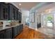 Hallway with dark cabinets, hardwood floors, and entryway with glass door at 175 Rehoboth Ln, Mooresville, NC 28117