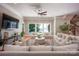 Bright living room featuring a neutral color palette, large windows with water views, and comfortable seating at 175 Rehoboth Ln, Mooresville, NC 28117