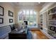 Home office with a large window, custom built-in shelves, and hardwood floors at 175 Rehoboth Ln, Mooresville, NC 28117