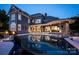 Luxury home featuring outdoor pool and hot tub with elegant stone accents and evening ambiance at 175 Rehoboth Ln, Mooresville, NC 28117