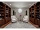 Inviting sitting area with custom built-ins, a round window, and hardwood floors, perfect for relaxing and reading at 175 Rehoboth Ln, Mooresville, NC 28117