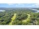 An aerial view of a golf course with tree-lined fairways and blue skies at 177 Yadkin Falls Rd, New London, NC 28127