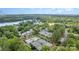 An aerial view of a tennis court and pool surrounded by trees, near a lake at 177 Yadkin Falls Rd, New London, NC 28127