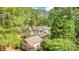 An elegant home with a metal roof surrounded by lush green trees and landscaped lawns at 177 Yadkin Falls Rd, New London, NC 28127