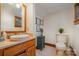 Bathroom with a vessel sink, framed botanical prints, and neutral tile flooring at 177 Yadkin Falls Rd, New London, NC 28127