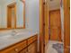 Bathroom featuring wood cabinets, a large mirror, and a shower/tub combo at 177 Yadkin Falls Rd, New London, NC 28127
