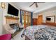 Bedroom with a fireplace, TV, French doors, and a patterned bedspread at 177 Yadkin Falls Rd, New London, NC 28127