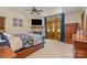 Bedroom with a fireplace, TV, French doors, and a patterned bedspread at 177 Yadkin Falls Rd, New London, NC 28127