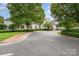 Elegant clubhouse entrance with portico, brick walkway, and manicured landscaping at 177 Yadkin Falls Rd, New London, NC 28127