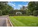 Well-manicured entrance to The Old North State Club with beautiful landscaping and signage at 177 Yadkin Falls Rd, New London, NC 28127