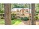 A beautiful exterior view with a stone pathway and verdant lawn framed by trees at 177 Yadkin Falls Rd, New London, NC 28127