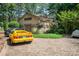 Exterior view of a home with a yellow sports car parked in front, surrounded by trees at 177 Yadkin Falls Rd, New London, NC 28127