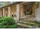A stone-clad front porch with a seating area and landscaped surroundings offers a relaxing welcome at 177 Yadkin Falls Rd, New London, NC 28127