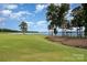 Picturesque view of golf course with lake and mature trees on a sunny day at 177 Yadkin Falls Rd, New London, NC 28127