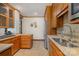Kitchen with stainless steel refrigerator, double sink and wooden cabinets at 177 Yadkin Falls Rd, New London, NC 28127