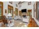 Bright living room with vaulted ceilings, a stone fireplace, wood trim and large windows at 177 Yadkin Falls Rd, New London, NC 28127