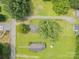 Aerial view showing the house, yard and outbuildings surrounded by lush greenery and other homes nearby at 201 Oakland Dr, Lowell, NC 28098