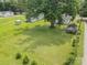 Aerial view showing the home, its yard, outbuildings, and surroundings, all surrounded by lush greenery at 201 Oakland Dr, Lowell, NC 28098