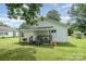 Cozy home exterior featuring a small porch, BBQ grill, and green lawn at 201 Oakland Dr, Lowell, NC 28098