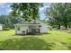 Charming home exterior with a small porch, grill, and well-maintained lawn at 201 Oakland Dr, Lowell, NC 28098