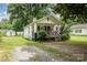 Charming single-story home with a welcoming front porch, shed, and a well-maintained lawn at 201 Oakland Dr, Lowell, NC 28098