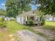 Charming single-story home with a welcoming front porch and a well-maintained lawn at 201 Oakland Dr, Lowell, NC 28098