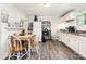 Eat-in kitchen featuring white cabinets, laminate floors, and modern appliances at 201 Oakland Dr, Lowell, NC 28098