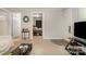 Bright living room featuring tan carpet and doorways leading to other rooms at 201 Oakland Dr, Lowell, NC 28098