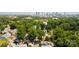 An aerial view of the neighborhood with a modern black home amidst lush greenery at 2107 W Trade St, Charlotte, NC 28216