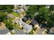 Aerial view of the neighborhood showcasing lush trees and modern black homes at 2107 W Trade St, Charlotte, NC 28216