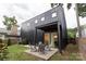Modern black home featuring backyard patio and outdoor seating at 2107 W Trade St, Charlotte, NC 28216