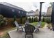 Backyard patio area with outdoor seating, surrounded by lush landscaping at 2107 W Trade St, Charlotte, NC 28216