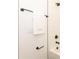 Close-up of bathroom fixtures, including matte black towel bar, shower head, and white subway tile at 2107 W Trade St, Charlotte, NC 28216