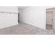 Bright bedroom featuring neutral carpet, base molding, and an open doorway at 2107 W Trade St, Charlotte, NC 28216