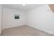 Cozy bedroom with neutral carpet, base molding, and a bright window at 2107 W Trade St, Charlotte, NC 28216