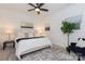 Bright bedroom featuring a cozy bed, stylish decor, and a ceiling fan at 2107 W Trade St, Charlotte, NC 28216