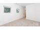 Bright, airy bedroom with natural light and neutral carpet at 2107 W Trade St, Charlotte, NC 28216