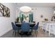 Open dining area featuring a stylish round table, blue chairs, and modern light fixture at 2107 W Trade St, Charlotte, NC 28216