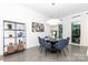 Modern dining room with round table, blue chairs, and an open shelf for storage at 2107 W Trade St, Charlotte, NC 28216