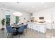 Bright dining and kitchen area featuring a modern design with white cabinets at 2107 W Trade St, Charlotte, NC 28216
