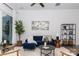 Cozy living room with plush blue sofa, modern decor, neutral tones, and bright lighting at 2107 W Trade St, Charlotte, NC 28216
