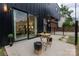 Back patio features wood furniture and string lights; view into the home's interior at 2107 W Trade St, Charlotte, NC 28216